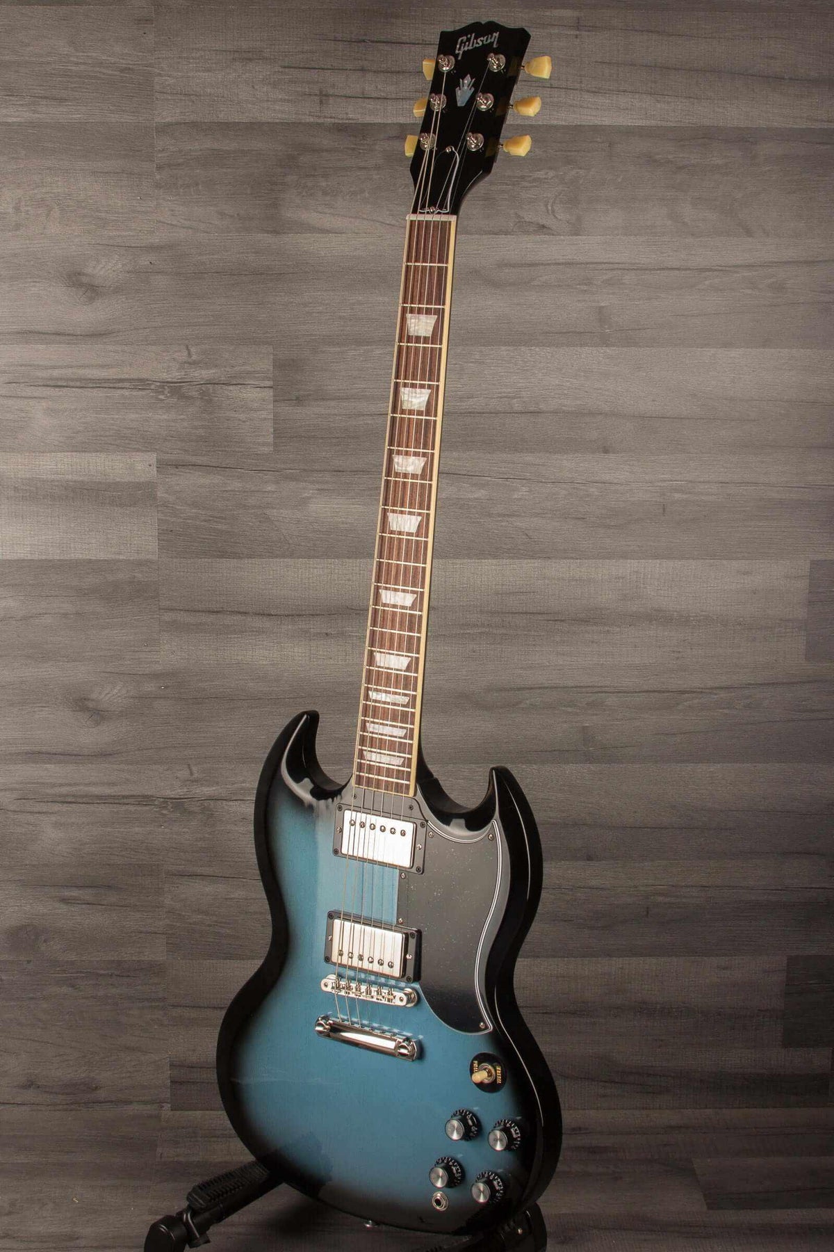 Gibson SG Standard '61 Stopbar Electric Guitar - Pelham Blue Burst displayed on a stand.