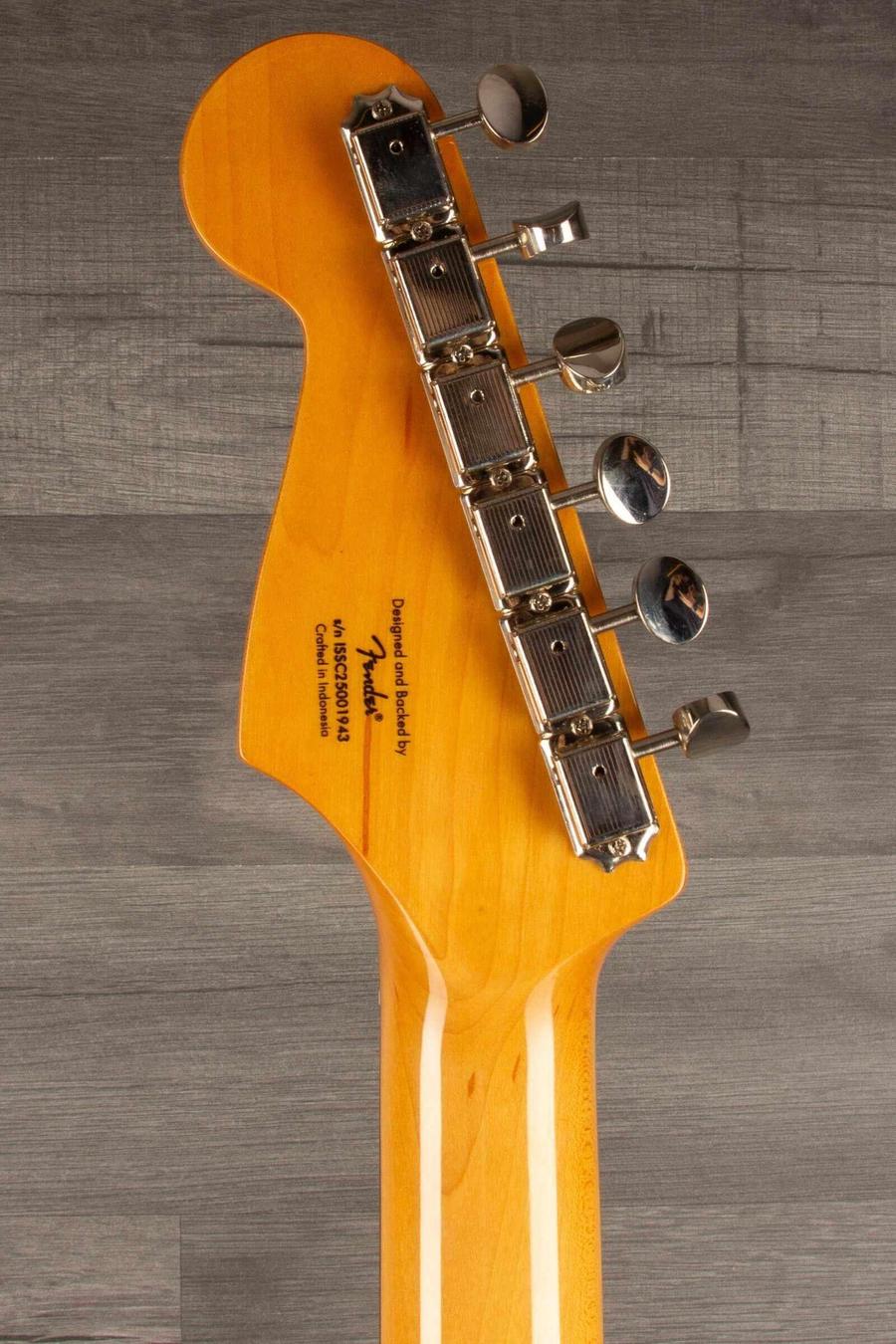 Close-up of the headstock of a Squier FSR Classic Vibe '60s Stratocaster, showcasing tuning pegs and neck detail.