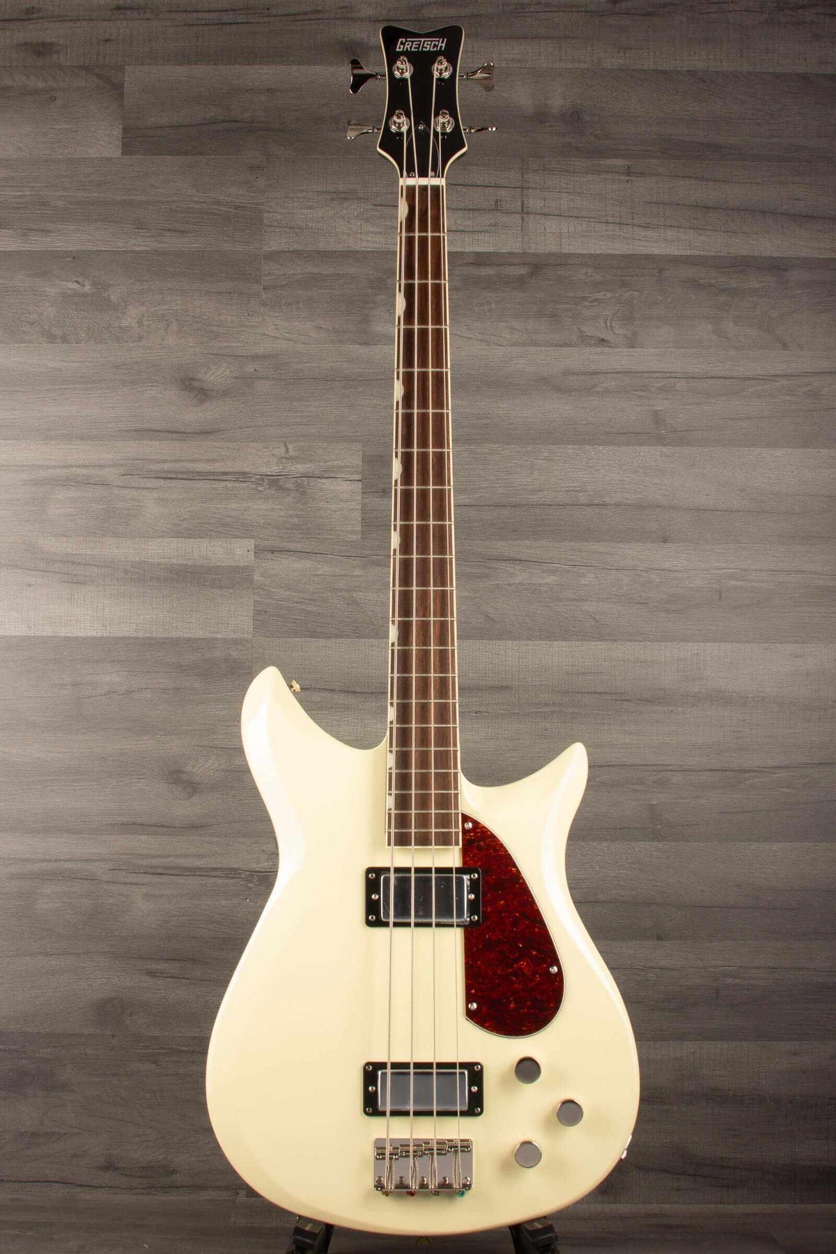 Gretsch   Electromatic® CVT Bass Double-Cut, Laurel Fingerboard, Vintage White on a display stand.