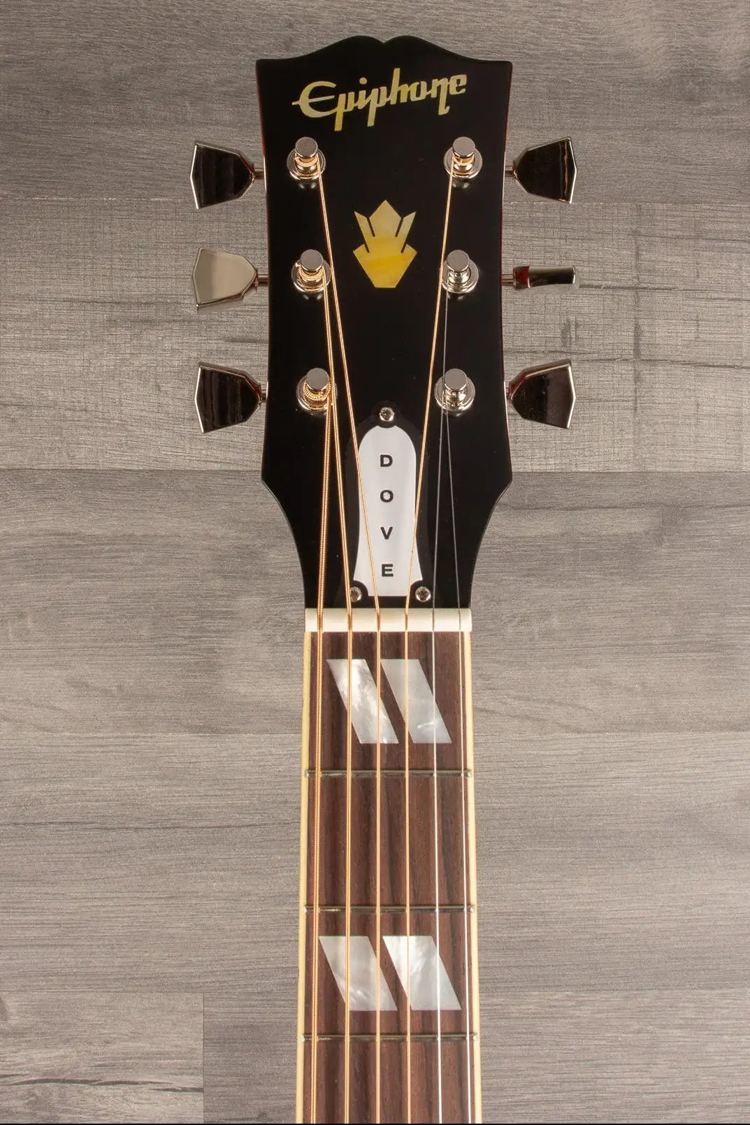 Guitar headstock with Epiphone logo on a wooden background