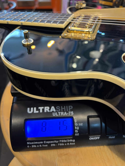 Gretsch Broadkaster® Jr. LX Center Block guitar on scale, showcasing its Midnight Sapphire finish and gold hardware.
