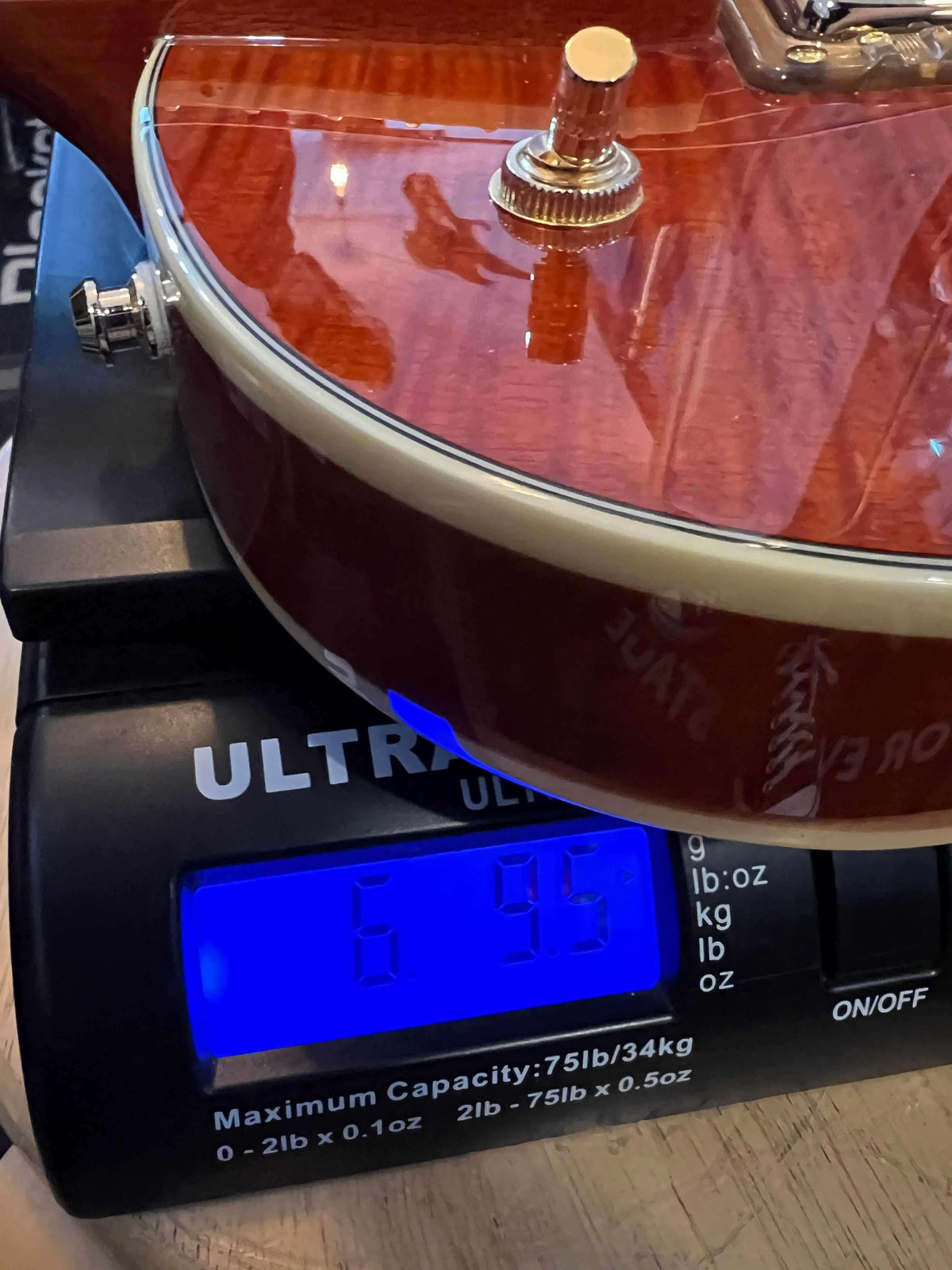 Gretsch  Electromatic® LTD Flame Okoume Broadkaster® Jr. Single -Cut with Bigsby®, Rosewood Fingerboard, Roundup Orange on scale showing weight