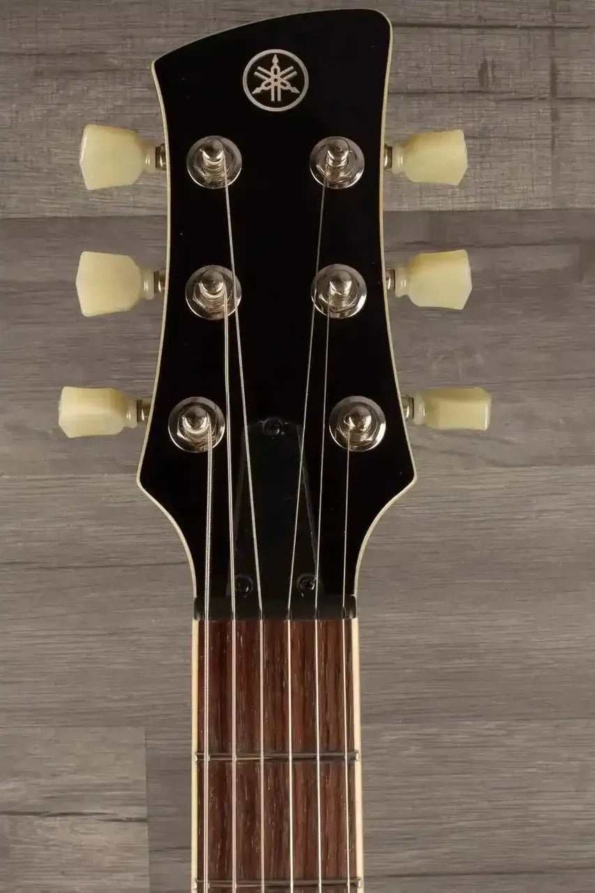 Yamaha RSS02T Revstar - Vintage White guitar headstock showing tuning pegs and strings.