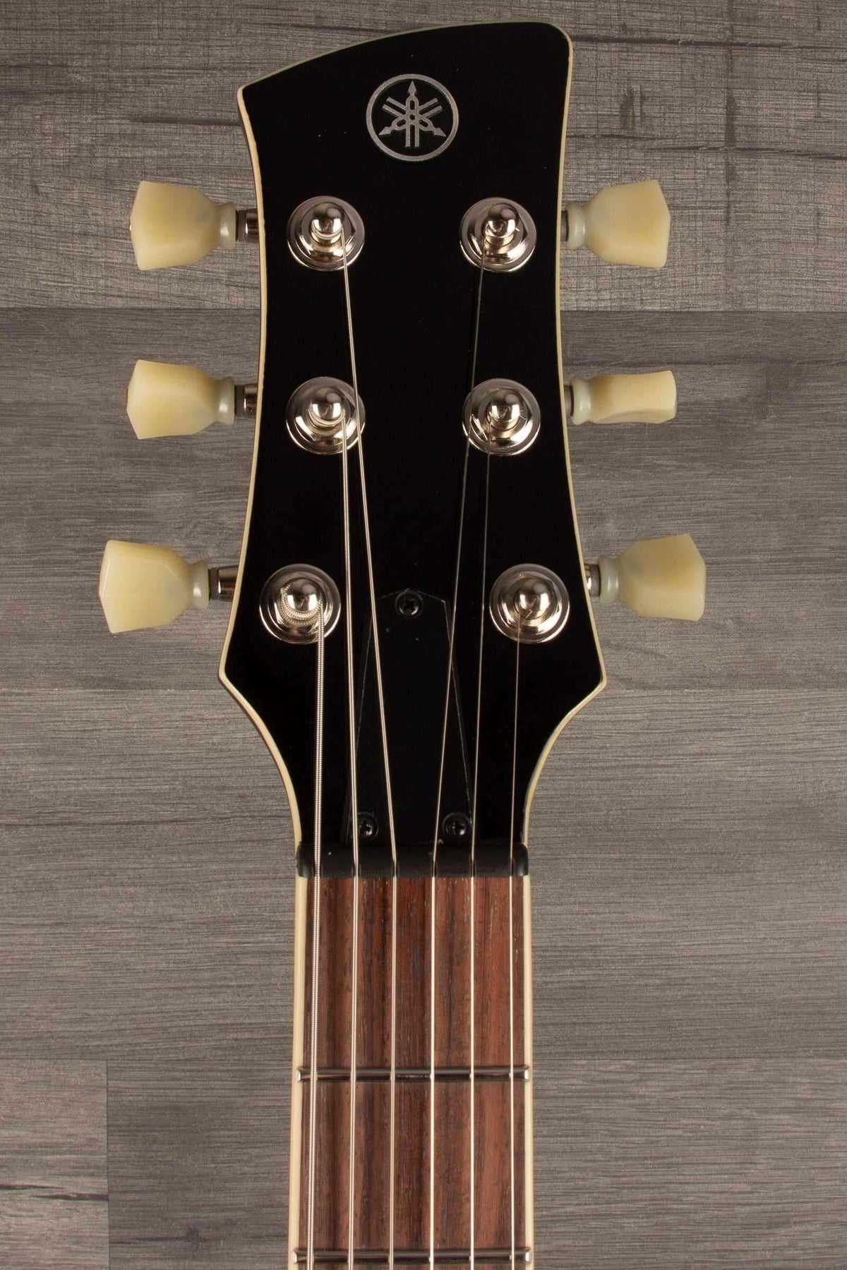 Yamaha RSS20 Revstar - Mist Green headstock view showcasing tuning pegs and strings.