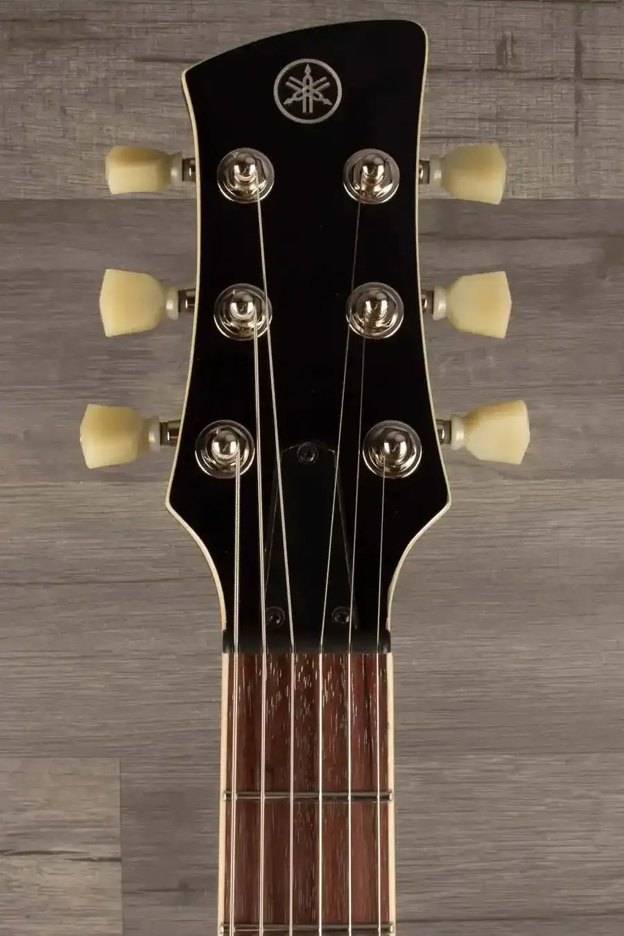 Yamaha RSS20 Revstar -Sonic Blue guitar headstock featuring tuning pegs and distinctive logo.