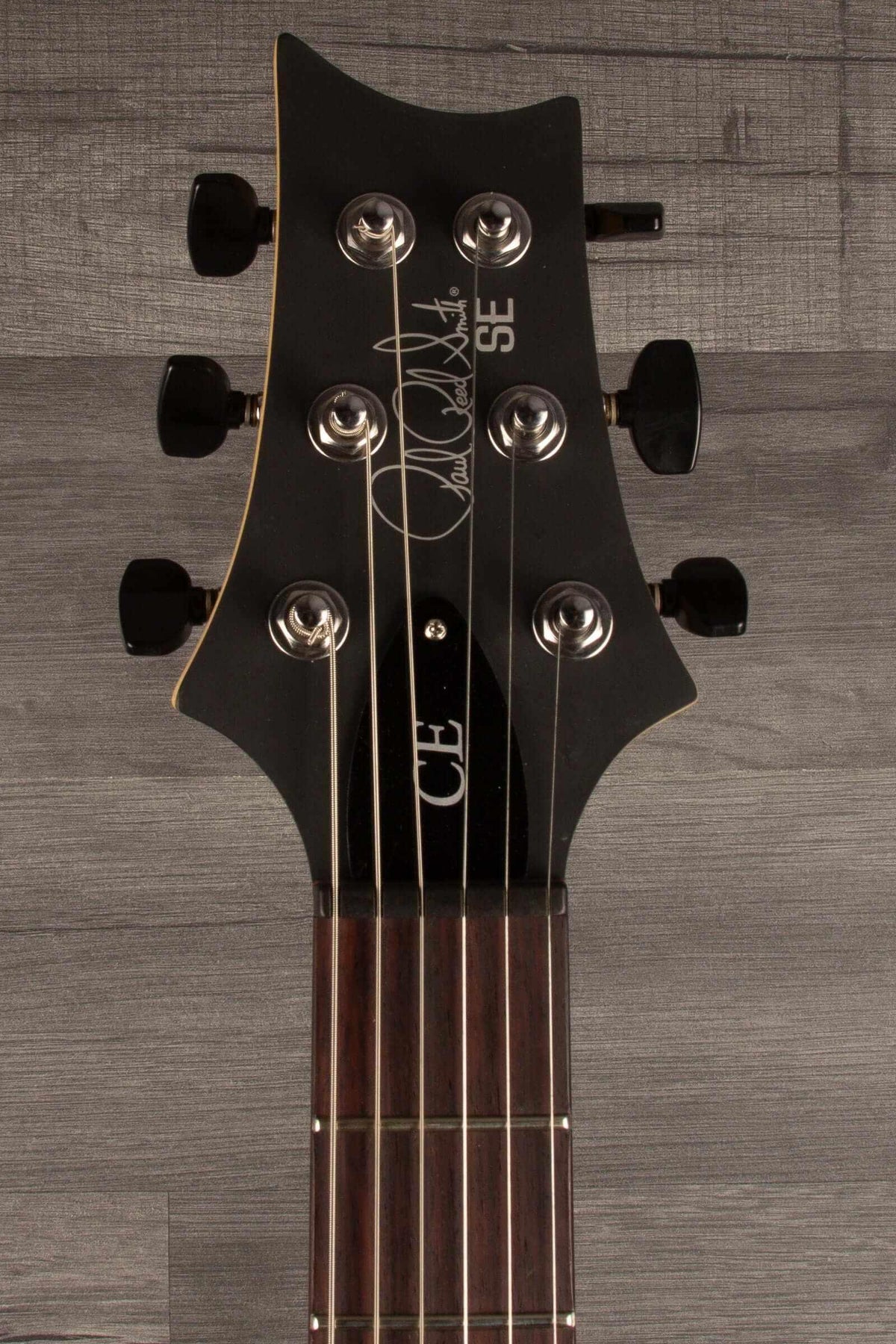 PRS SE CE24 Standard Stoptail guitar headstock showing tuning pegs and signature design.