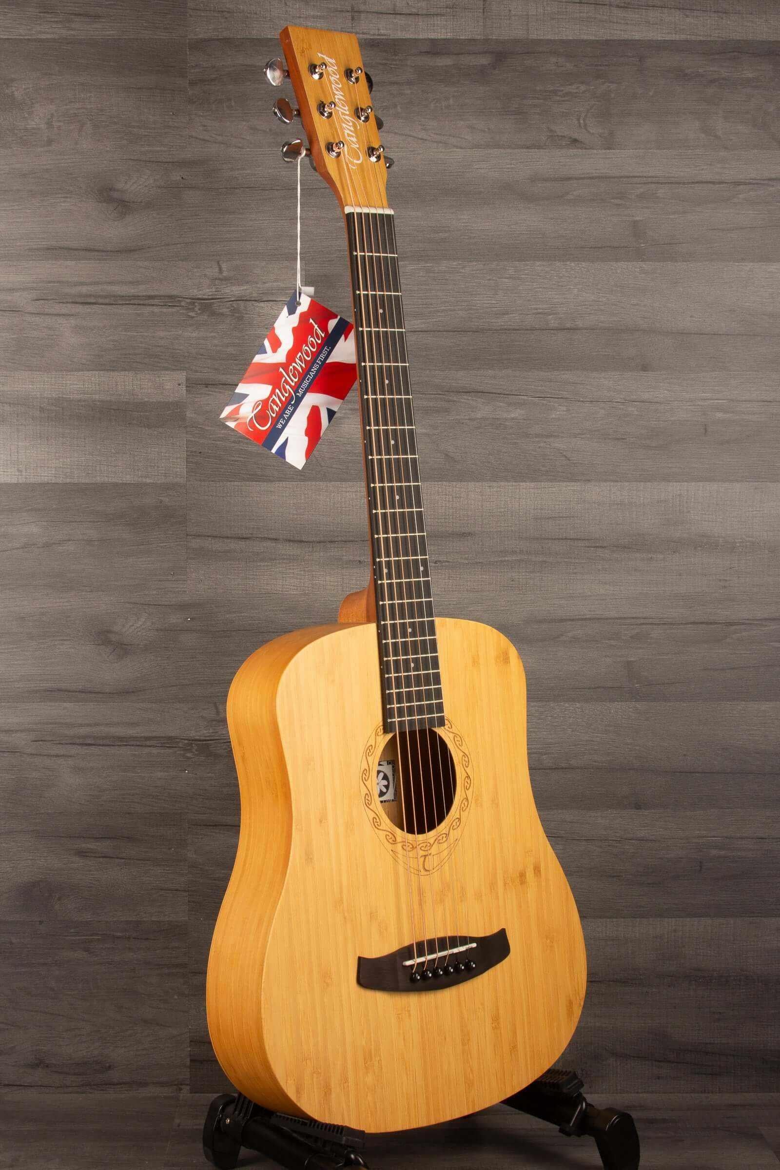 Tanglewood TWT18 Tiare Travel Acoustic, Natural Bamboo guitar displayed against a wooden background.