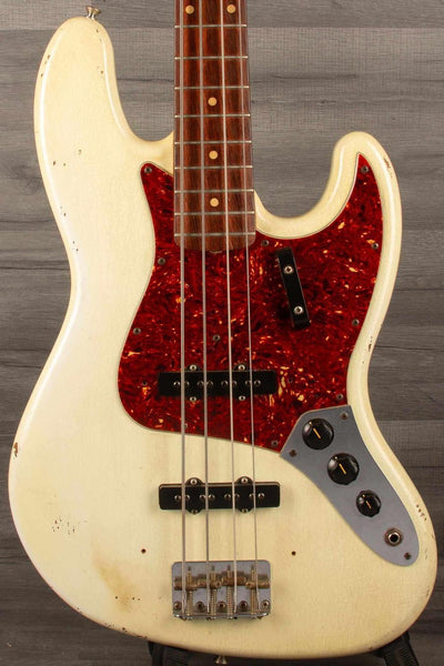 USED Fender Custom shop 64 Jazz Bass in good condition with original bridge and pickup covers.