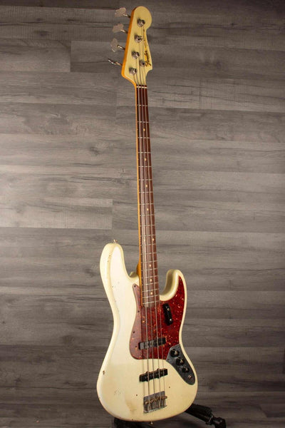 USED Fender Custom shop 64 Jazz Bass in good condition with heavy relic finish and original bridge and pickup covers.