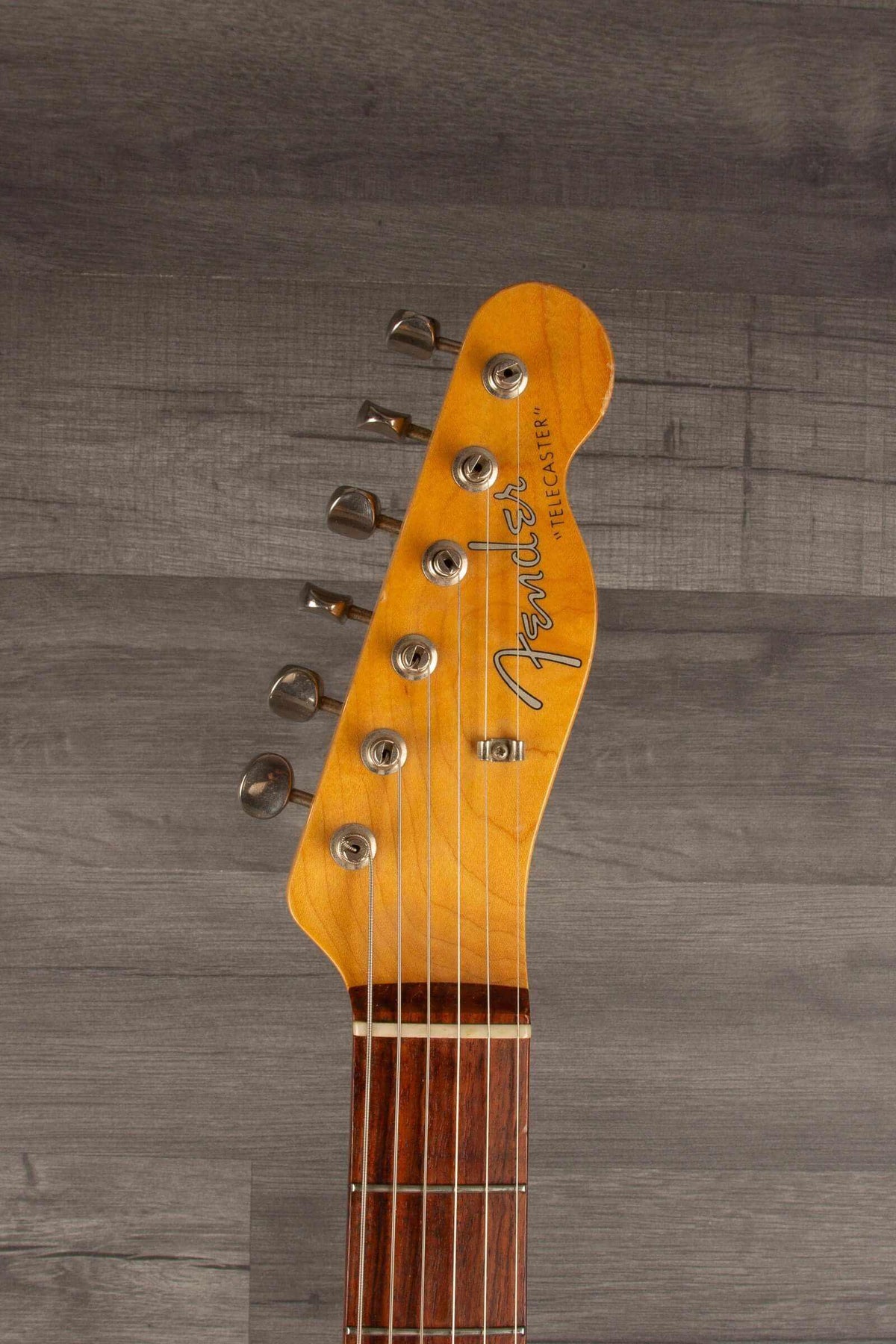 Close-up of Fender Japanese Traditional II 51 Nocaster used guitar headstock, showcasing tuning pegs and logo.