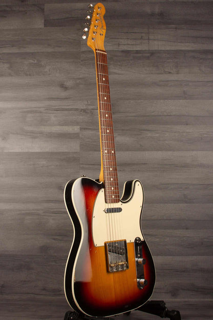 Fender Japanese Traditional II 51 Nocaster used guitar in 3 Tone Sunburst finish standing upright on a grey background.