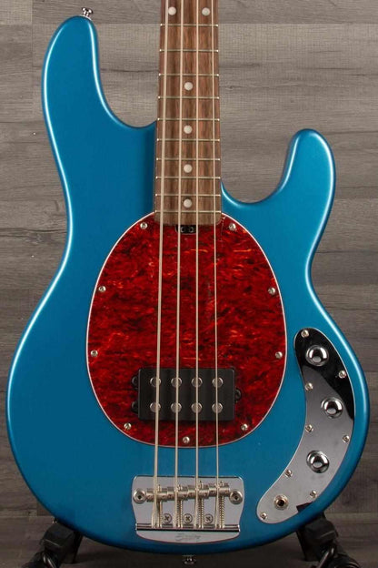 USED - Sterling by Music Man Stingray Ray24 Bass Guitar - Toluca Lake Blue, featuring a vintage design and vibrant blue finish.