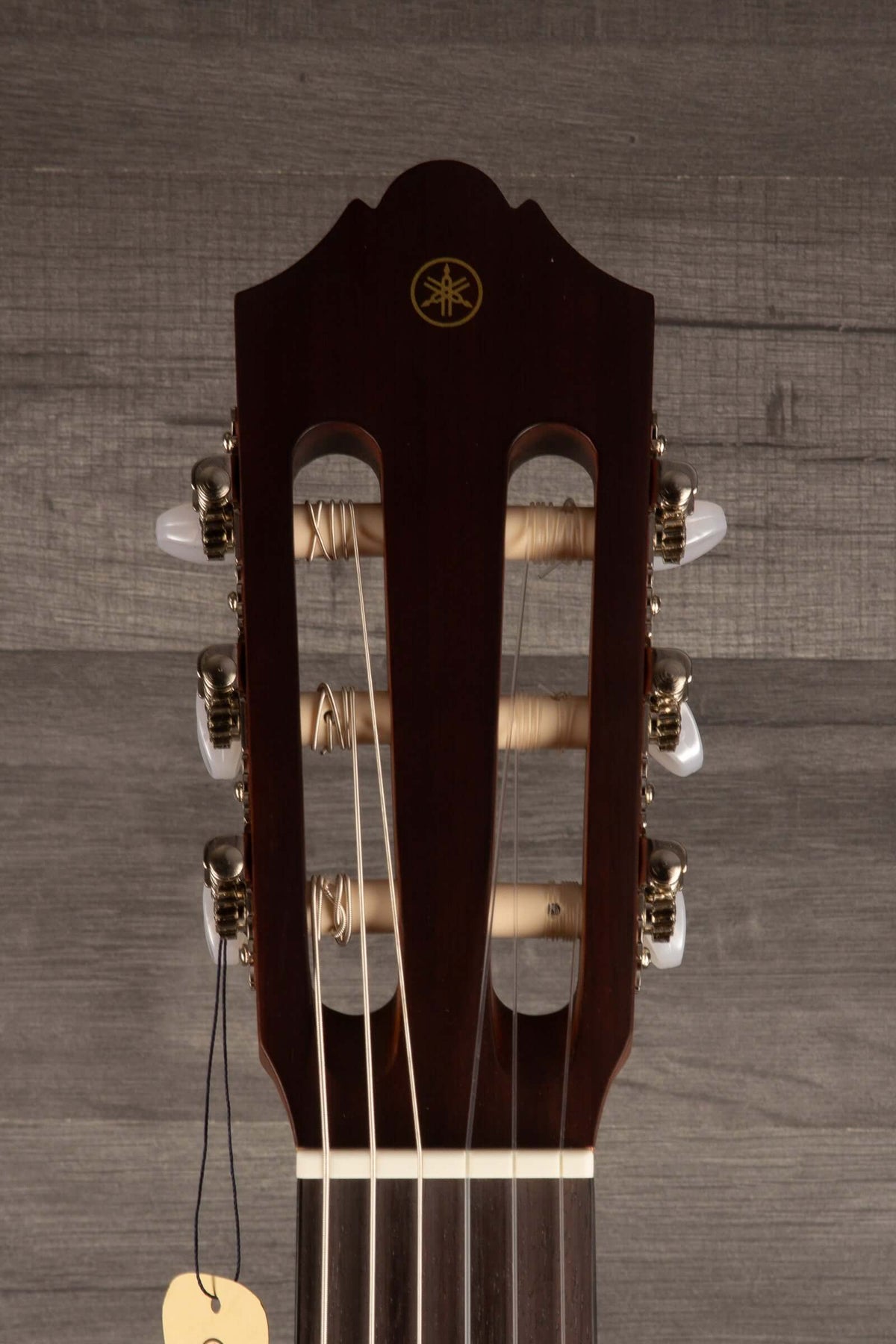 Yamaha CG122MS classical guitar headstock showcasing its elegant design and affordable classical guitar features.