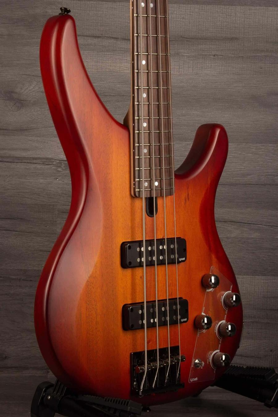 Yamaha TRBX504 Brick Burst Bass Guitar showcasing its mahogany body and Translucent Brown finish.