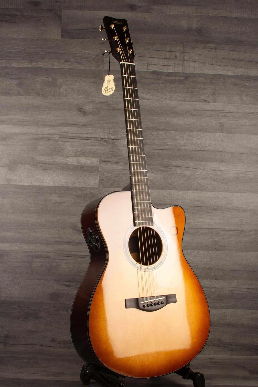 Yamaha TAS3C TransAcoustic Guitar - Sandburst displayed against a gray backdrop, showcasing its solid acoustic build.