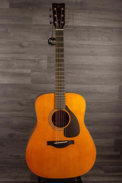 Yamaha FG5G - Acoustic Guitar displayed against a wooden backdrop, showcasing its solid sitka spruce top and African mahogany body.