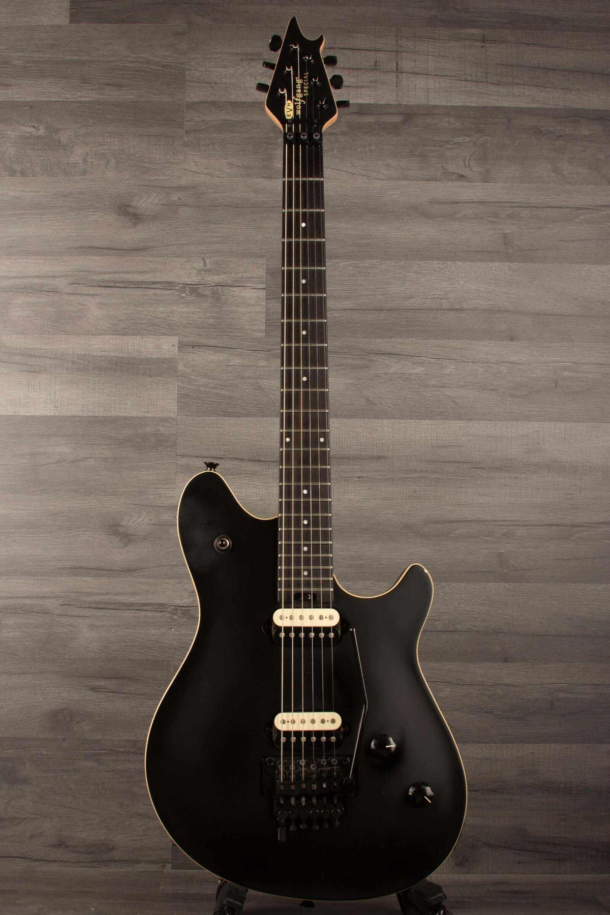 USED - EVH Wolfgang Special Stealth - Black (inc EVH hard case) showcased on display against a wooden background.