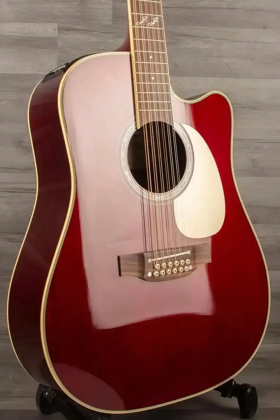 Takamine JJ325SRCL-12 John Jorgenson 12 string acoustic guitar with a glossy red finish.