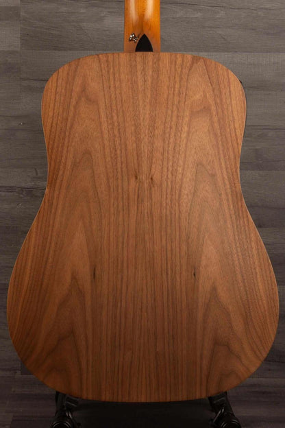 USED - 2022 Taylor 110e back view showcasing its solid wood craftsmanship and sleek design.
