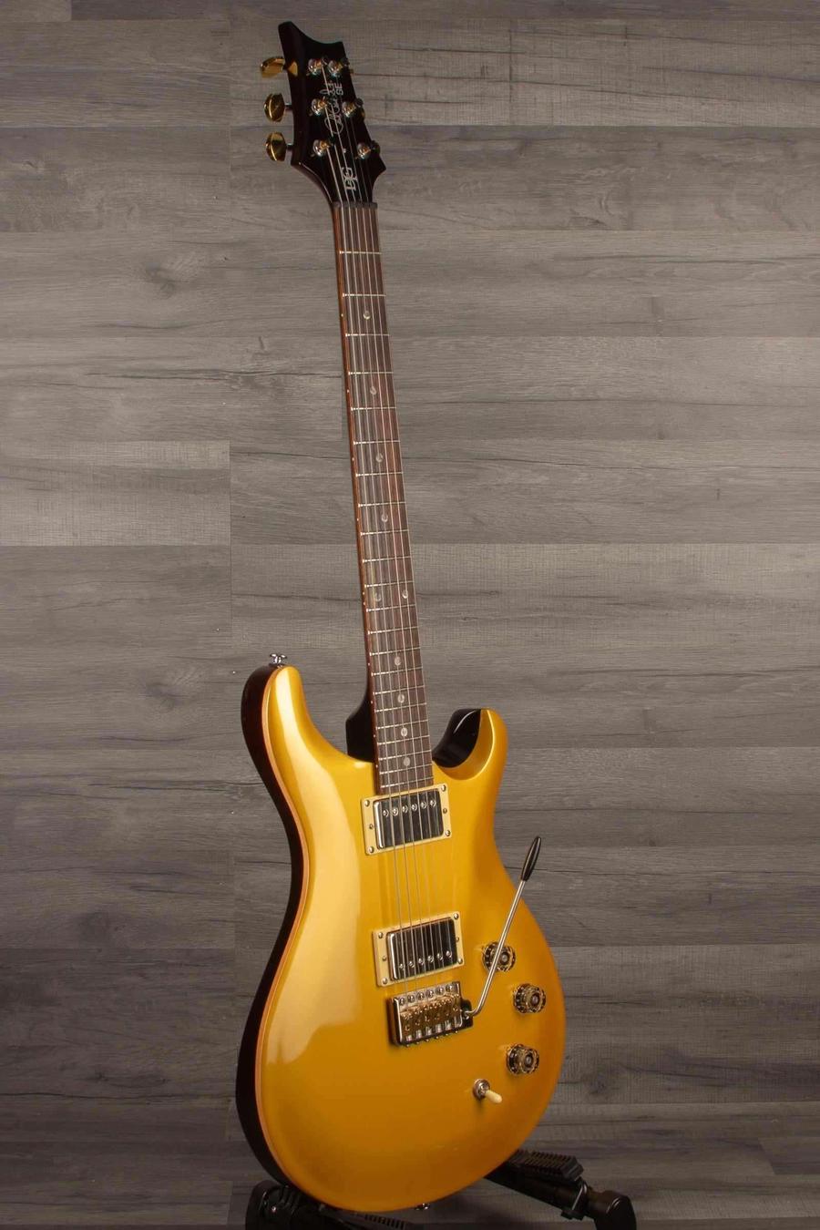 USED - PRS SE DGT Gold Top Electric Guitar side view on display with upgraded brass block and saddles.