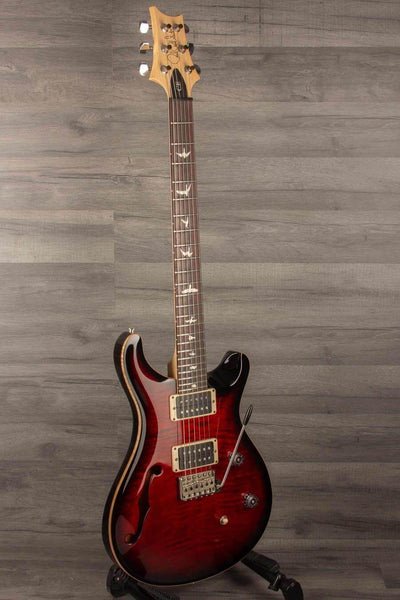 USED - PRS CE24 Semi Hollow - Fire Red guitar with F-hole design and mahogany body on display.