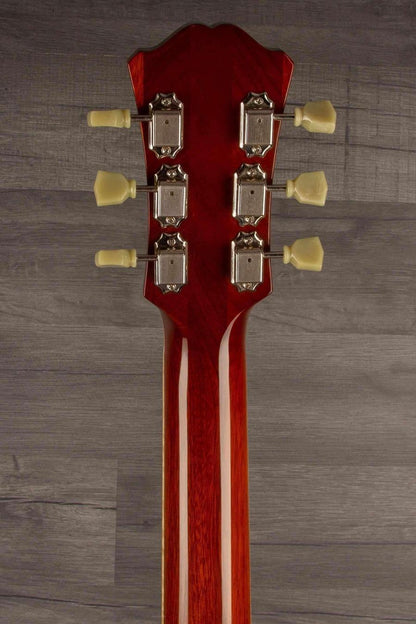 USED - Eastman T184MX - GoldBurst guitar headstock with tuning pegs on a wooden background.