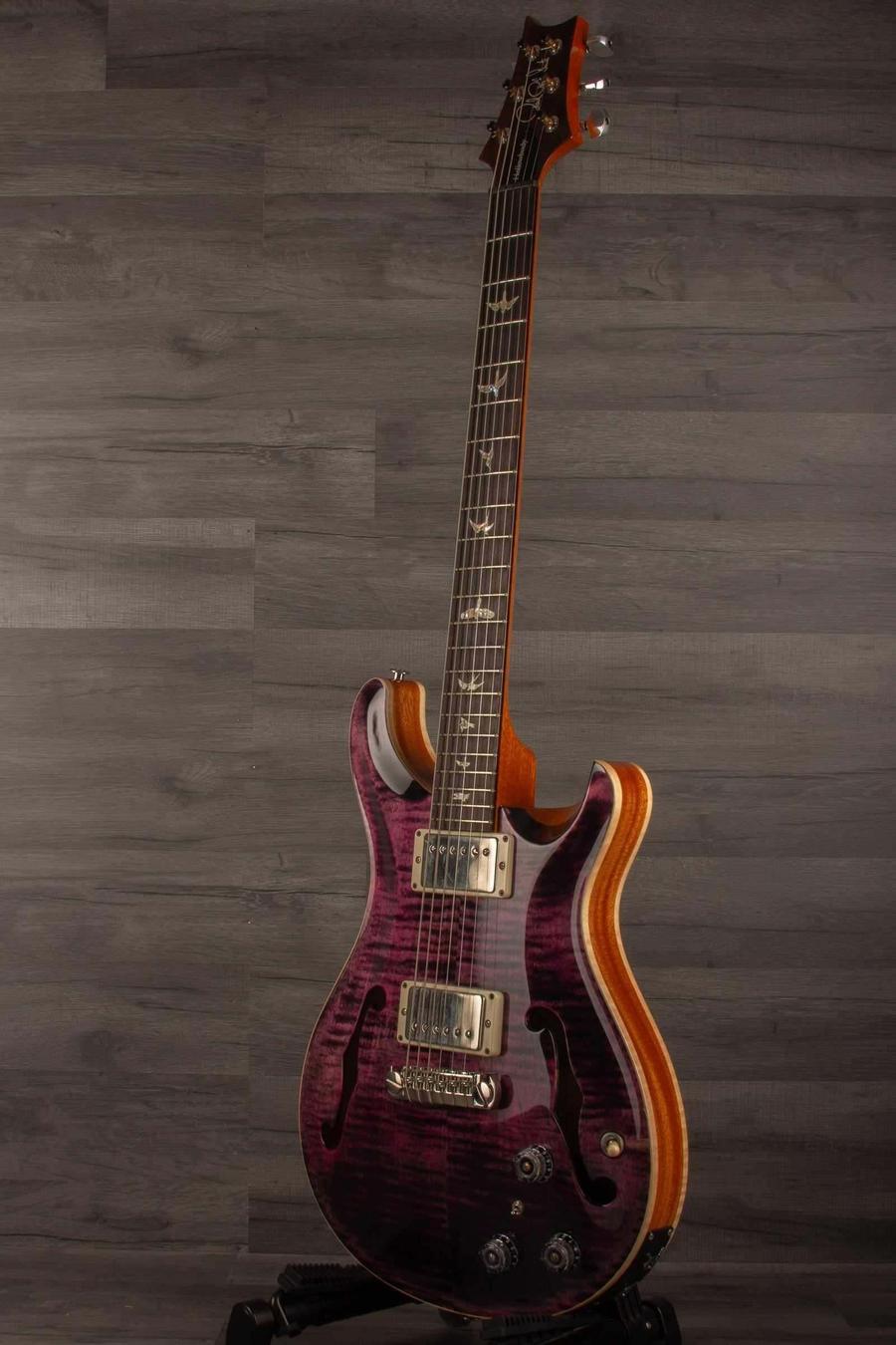 USED - PRS Hollowbody II Piezo Purple Iris displayed on a stand with a stunning purple iris finish.