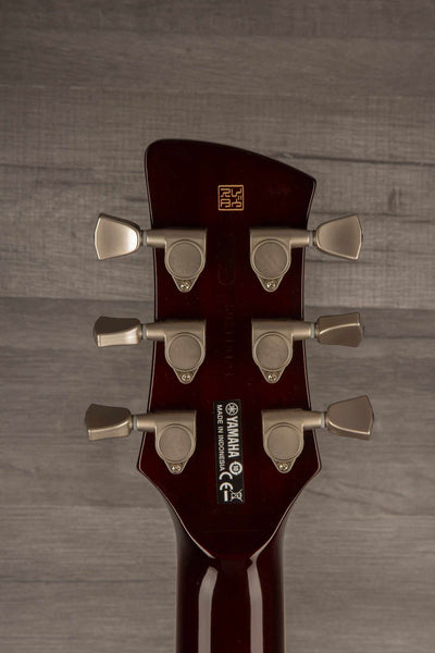 Yamaha RS502T FMX guitar headstock with tuning pegs and logo, showcasing its used condition and mahogany craftsmanship.