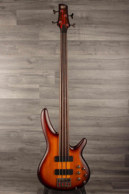USED - Ibanez SRF700 BBF SR fretless bass - Brown burst flat on display against a wood-like background.